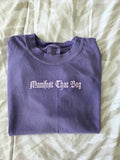 Manifest That Bag unisex motivational tee in grape – flat lay