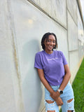 Manifest That Bag t-shirt in grape – front view Model posing against stone wall